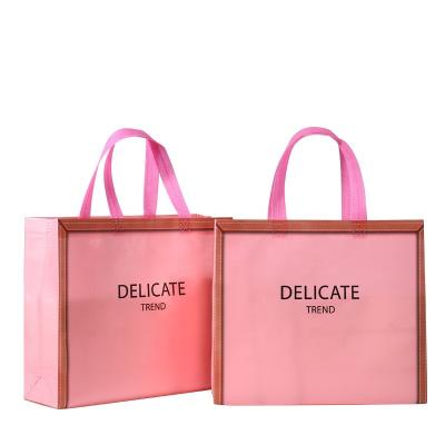 China Custom Handled Women's Nonwoven Tote Bags Logo Laminated Bags Simple Pink Clothing Store Handbags Customized Nonwoven Shopping Bags for sale