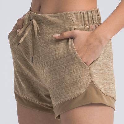 China Breathable Lightweight Waistband Women Sweat Quick Dry Yoga Shorts With Pockets for sale