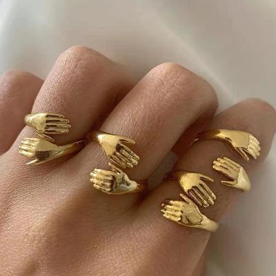 China High Quality European Classic 18K Gold Plated Open Hugging HandPromise Ring Personality Stainless Steel Hug Hands Rings For Couples for sale