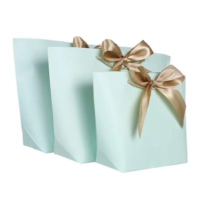 China Recycled Materials Kraft Paper Promotional Gift Bag With Bow for sale