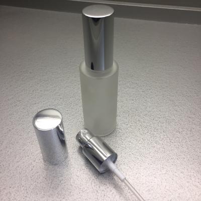 China 30ml cosmetic frosted face care serum lotion glass bottle with aluminum pump for sale