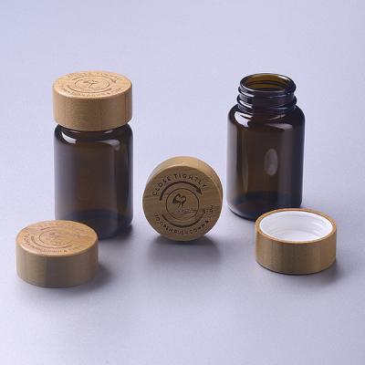 China hot-sale 100ml glass pharmaceutical container with bamboo child resistant cap for sale