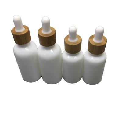 China available Cosmetic White Opa with Bamboo Dropper 10ml essential oil glass bottle for sale