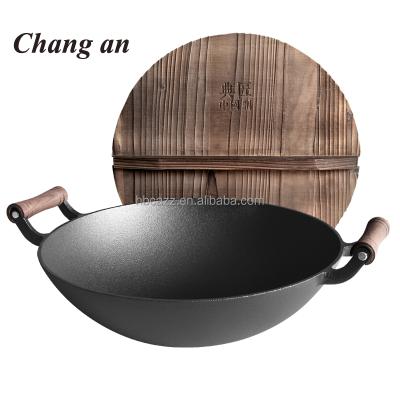 China Sustainable Cast Iron Vegetable Oil Coating Kitchen Wok With Wooden Loop Handle for sale