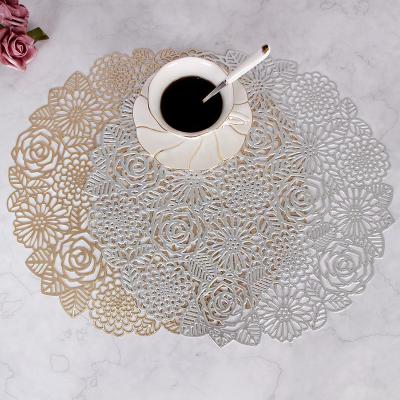 China Viable Silver Hollow Table Mats Home Dining Table Christmas Wedding PVC Gold Flower Heat Resistant Place Mat for sale