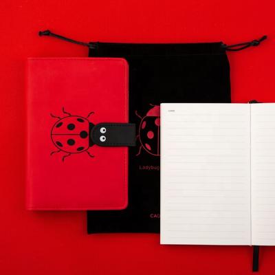 China New arrival leather cover pocket custom magnetic a6 hardcover notebook with pen holder for sale