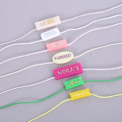 China Viable Custom Design Plastic Apparel Garment Seal String Hang Tag for sale