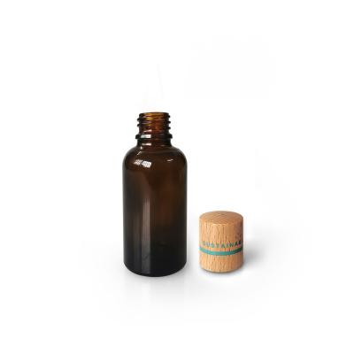 China Eco - Friendly Refillable 30ml Essential Oil Amber Glass Bottle Sustainable Cosmetic Packaging With Bamboo Cap for sale