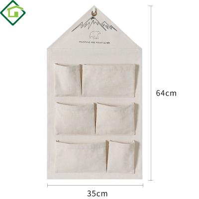 China Viable Multi-Function Canvas Cotton Canvas Bag Wall Hanging Storage Bag Hanging Organizer for sale