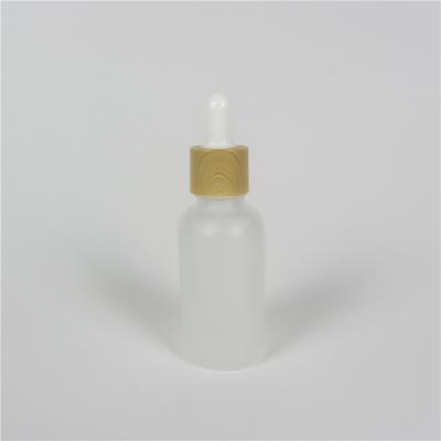 China Cosmetic Wholesale Frosted Glass Dropper Bottles Cap Essential Oil Glass Bamboo Bottles With Dropper for sale