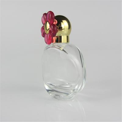 China Eco - Friendly 30ml Flower Glass Perfume Spray Bottle With Red Cap Clear Round Perfume Bottles for sale