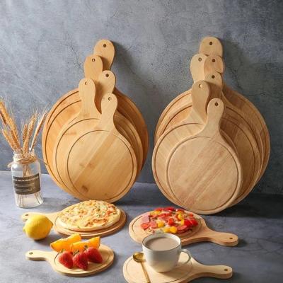 China Sustainable round pizza board for kitchen and cutting board with handle for baking pizza and bread for sale