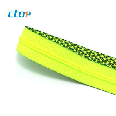 China Cheap Sustainable Shine Green Logo Print Fancy Long Chain Nylon Zipper For Fabrics for sale