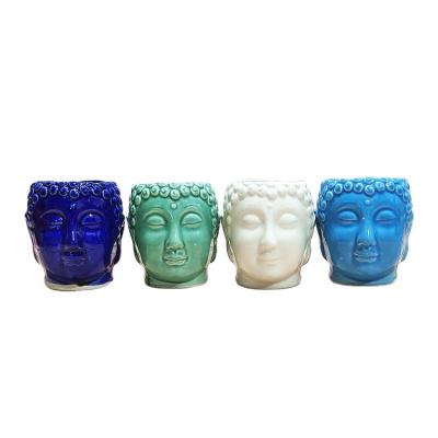 China Minimalist ceramic flower pot with Buddha head home desktop office balcony decoration portrait cement flower pot for sale