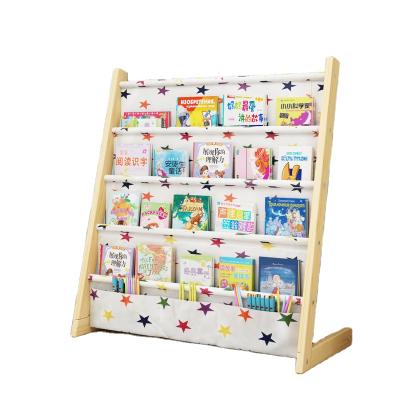 China Convenient Children's Bookshelf Cartoon Floor Home Bookshelf Kindergarten Baby Racks Simple Solid Wood Pupils Picture Book Rack for sale