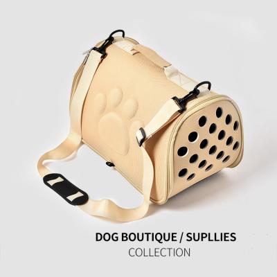 China Breathable Pet Supplies Hollow Out Diagonal Footprint Eva Pet Outing Bag Portable Dog Carrier Bag for sale