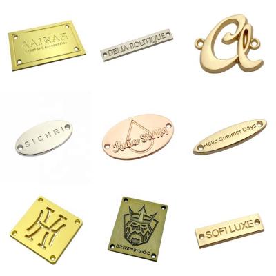 China Washable Fashion Design Custom Embossed Logo 2 Hole Metal Labels Tags For Coat / Hat for sale