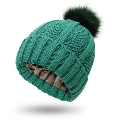 China COMMON Winter Knit Pompom Custom Women's Faux Fur Hat Pom Pom Beanie Hat With Satin Lining for sale