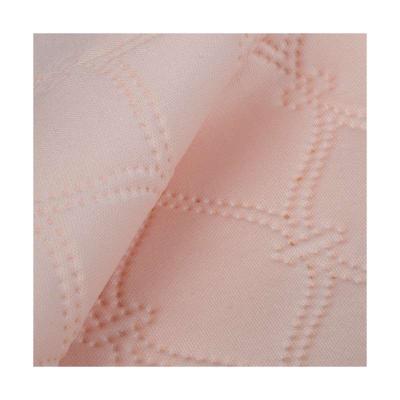 China Good quality breathable hot selling pink embossed stretch jacquard quilted knit fabric polyester double for sale