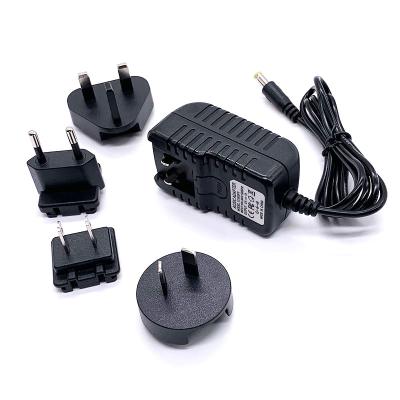 China Powered By 12V1A 9V1A 5V2A US Au Eu British DC Adapter With Interchangeable Plugs Power Fit for sale