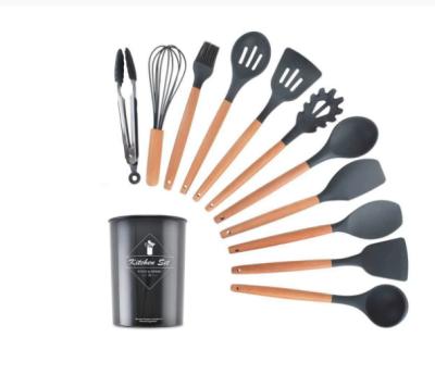 China Traditional non-stick heat resistant silicone kitchen utensil set with natural wooden handles complete with tongs and silicone utensil for sale