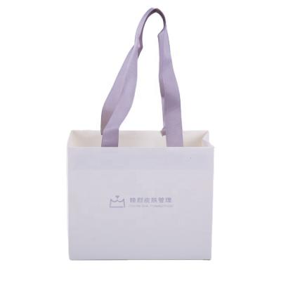 China Recycled Materials Luxury Custom Design Wholesale White Logo Kraft Paper Bag Fashion Paper Bag Cardboard Bags With Handles Custom Gift Packaging for sale