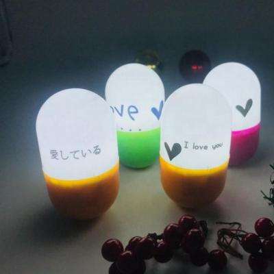 China Colorful Room LED Night Lighting 3D Pill Rocker Lamp Baby Newest Colored Led Light for sale