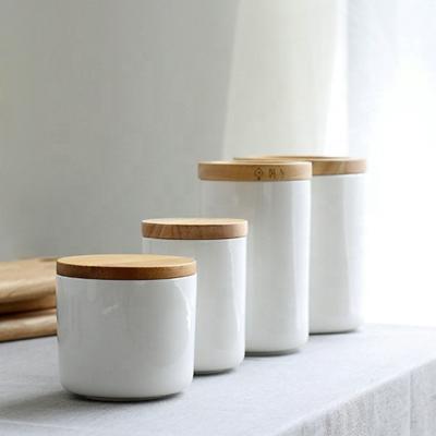 China Modern Custom Logo Wholesale Empty White Ceramic Candle Jars With Wooden Lids for sale