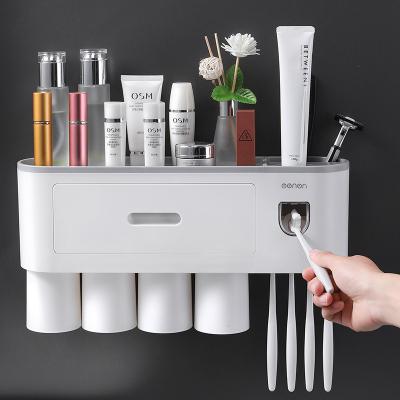 China Sustainable Bathroom Accessories Wall Mounted Automatic Toothpaste Dispenser Squeezer Toothbrush Holder for sale