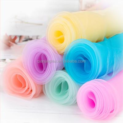 China New arrival anti-static cheap polyester organza sheer fabric 42 colors for dress for sale