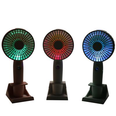 China 2022 New Colorful Cool LED USB Air Fan Portable Handheld 3 Speed ​​Travel Desktop Moisturizing Spray Air Cooling Small Water Spray Mist Mini Fan with Phone Holder for sale