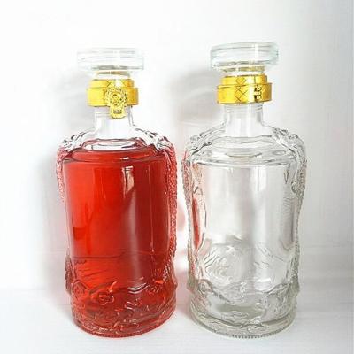 China Unique Beverage Dragon Shape Liquor Bottle 500ml XO Glass Bottle For Whiskey Vodka for sale