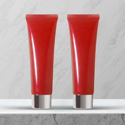 China Cosmetic Easy To Carry Simple Design Round Red Cosmetic Hand Cream Plastic Pipe for sale