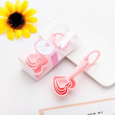 China Viable Creative Heart Shaped Plastic Doser Measure Spoons For Wedding Party Gift Baby Shower Favors for sale