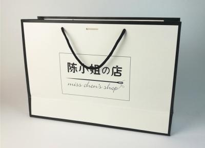 China Portable paper bag custom printed logo gift bag advertising white card paper bag garment bag paper bag custom logo for sale