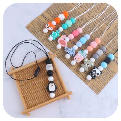 China Dinosaur Soft Beads Donut Silicone Food Grade Toy Necklace Baby Silicone Teether Pendant Necklace for sale