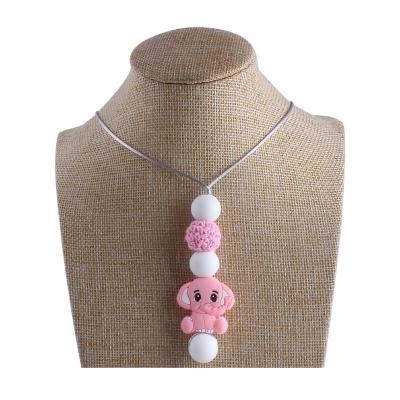 China Dinosaur Soft Beads Donut Silicone Food Grade Toy Necklace Baby Silicone Teether Pendant Necklace for sale