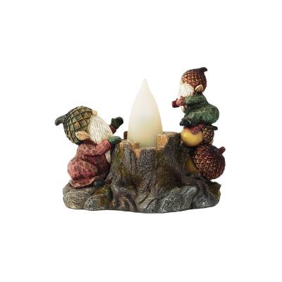 China Sitting on Pinecones 2022 Christmas Little Gnomes Minimalist Home Decor Figurine Set with Led Flame Light for sale