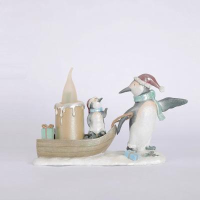 China Contemporary Resin Crafts Penguin And His Baby Statues And Boat Figurines With Led Candle For Home Decor Statue for sale