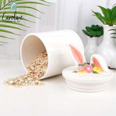 China Caroline Wholesale Ceramic 3D Easter Bunny Pink Ear Lid Food Cookie Storage Candy Jar Viable Canister for sale