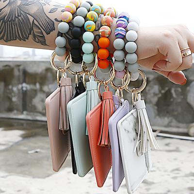 China Hot Wrist Wallet Holder Credit Card Pocket Bangle Key Ring Silicone Pearl Silicone Souvenir Gifts Promotion Sale Key Chain for sale