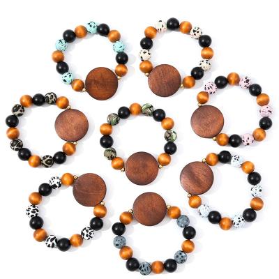 China Souvenir Gifts Promotion Good Quality Handmade Bohemian Leopard Silicone Beads Stretch Wood Beaded Bracelet With Wooden Disc for sale