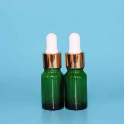 China Personal Care 10ml Essential Oil Glass Dropper Bottle Green Glass Matte Aluminum Gold Glass Dropper Bottle for sale