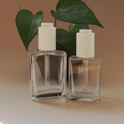 China Cosmetic 30ml and 50ml clear square glass bottle with white press essential oil dropper for sale