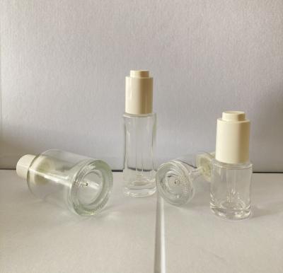 China 15ml 30ml 50ml clear cosmetic flat shoudle glass bottle with white button pump dropper for sale