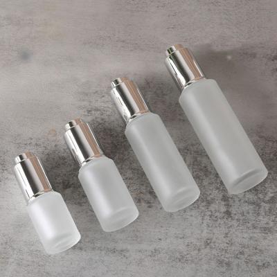 China 15ml 20ml 30ml 50ml gel cosmetic jar with press silver dropper cylinder clear glass bottle with press pump dropper for sale