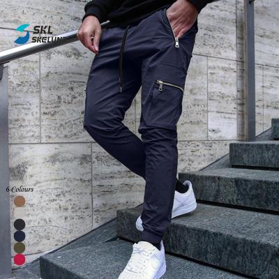 China Logo Cargo Pants Men Custom QUICK DRY Jogger Pants Casual Sportswear Sweat Gym Stacked Joggers Pants With Side Pockets for sale