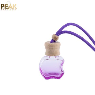 China Cosmetic High Quality Apple Shaped Car Air Freshener 5ml Glass Empty Perfume Hanging Bottle for sale