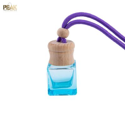 China New Car Aroma Diffuser 10ml Cosmetic Hanging Car Perfume Bottle With Wooden Cap for sale