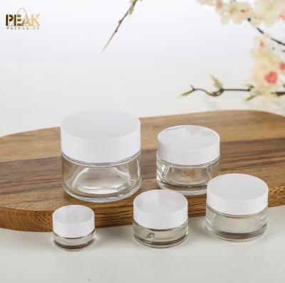 China wholwholesale 5g 10g 15g 20g 30g 50g 60g 100ml 200g empty clear cosmetic cream glass jars with white plastic lids caps for sale